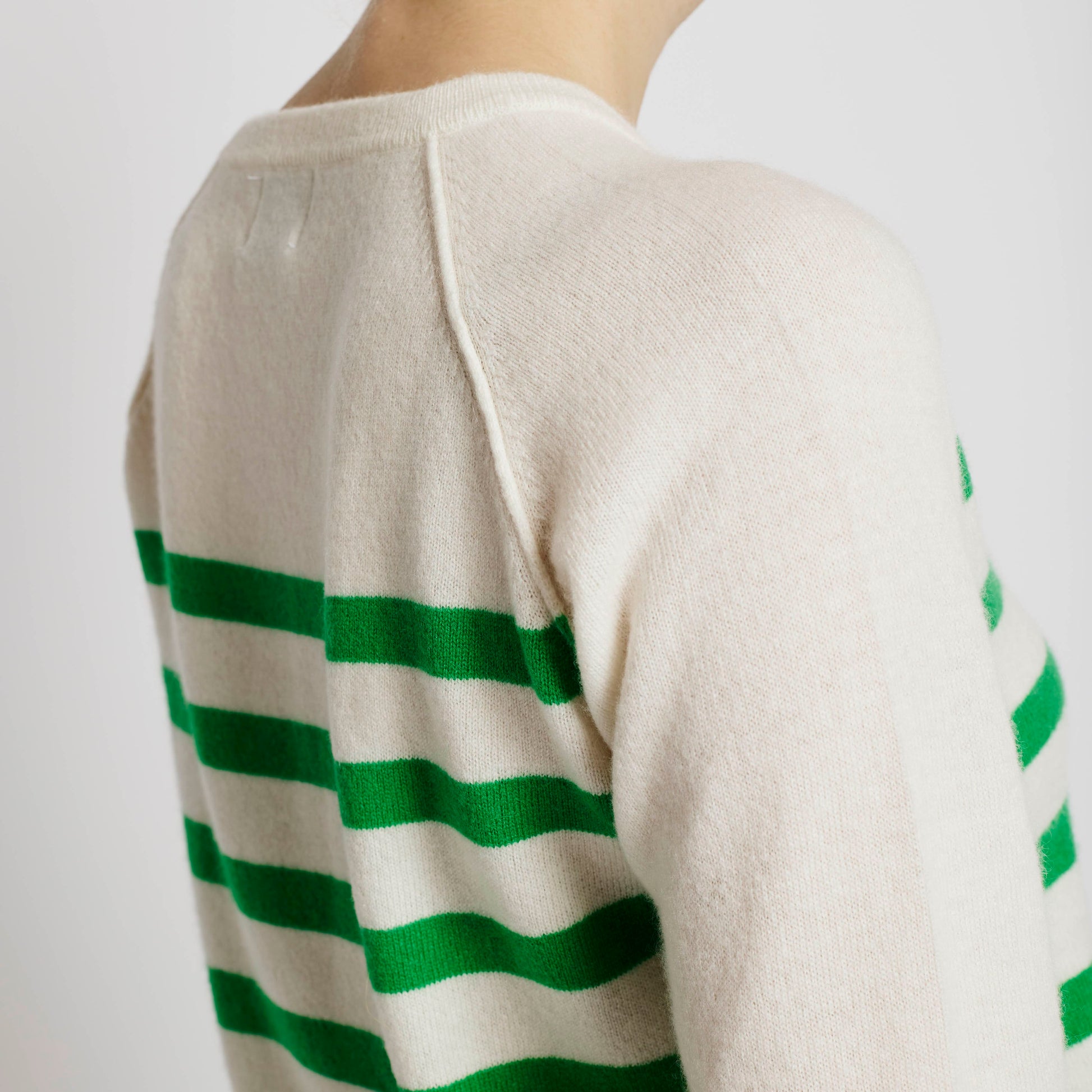 Alabaste Le Breton cashmere striped sweater in spring green and cream, back and shoulder close-up showing raglan seam and texture, 100% Mongolian cashmere.