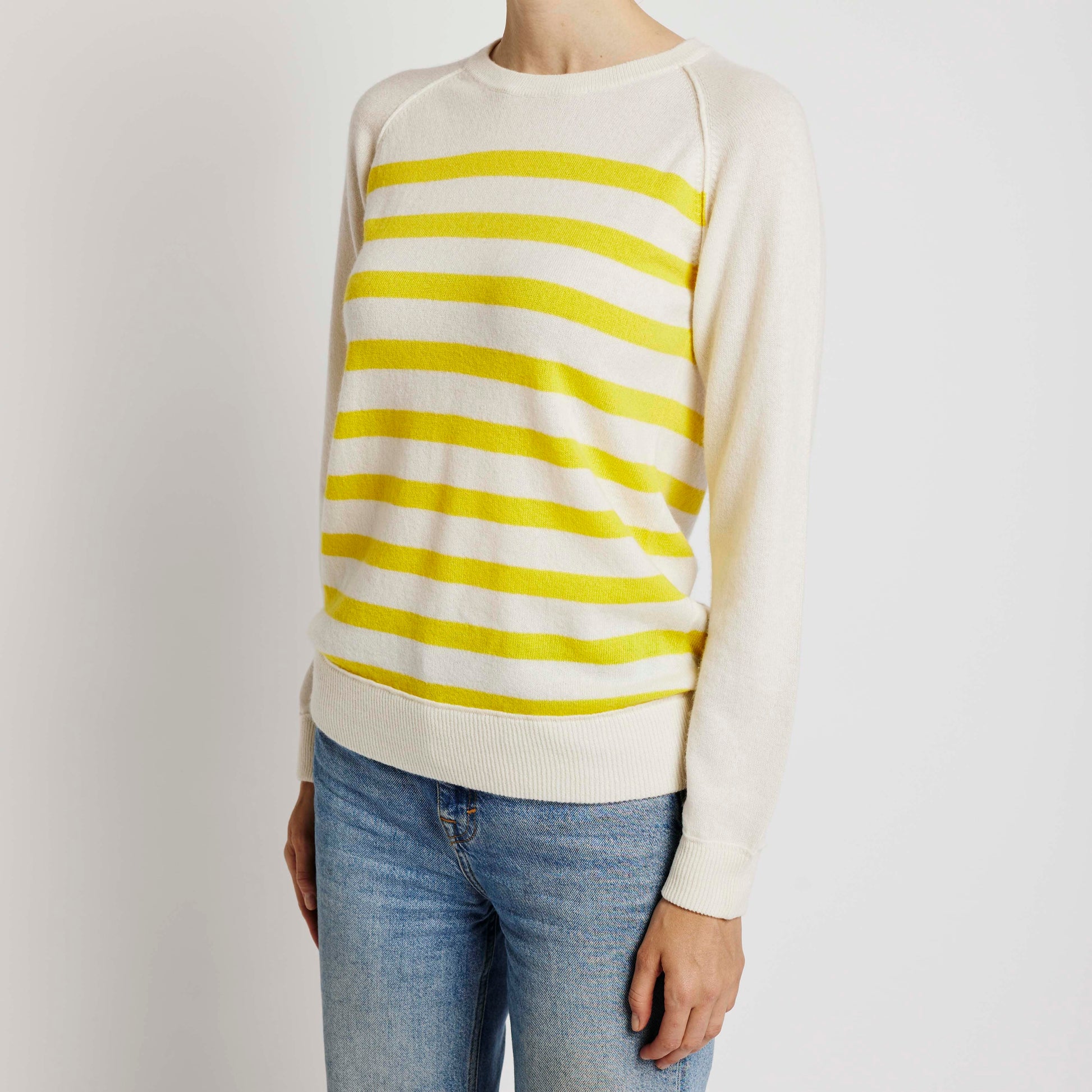 Alabaste Le Breton cashmere sweater in yellow and cream, front view on model wearing size small, featuring horizontal stripes and raglan sleeves, made from 100% Mongolian cashmere.